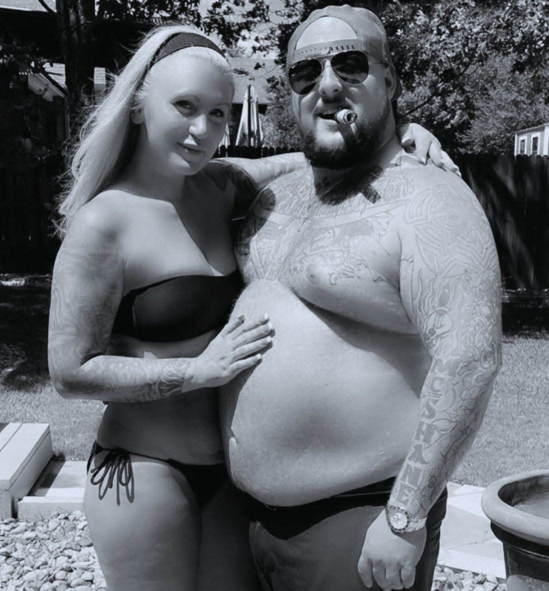 Rory McShane, cigar and 'MCSHANE' forearm tattoo, at a backyard pool